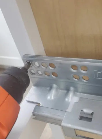 8) Install the pull out portion of the drawer glide. Enter the cabinet through the top and lower the glide into the cabinet. Push it out through the front and back to the 