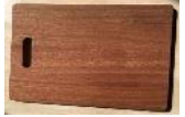 Cutting board made of Sapele hardwood and fits onto sink ledge.